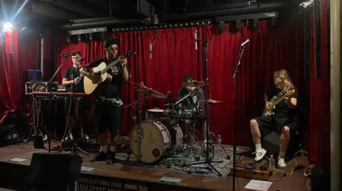 A band soundchecking on stage.