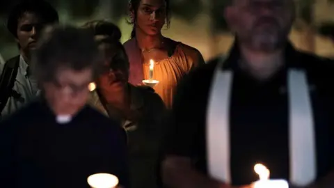EPA People hold candles during a vigil hosted by Centro San Antonio for those who have died in the flooding across Texas in San Antonio, Texas, USA, 07 July 2025