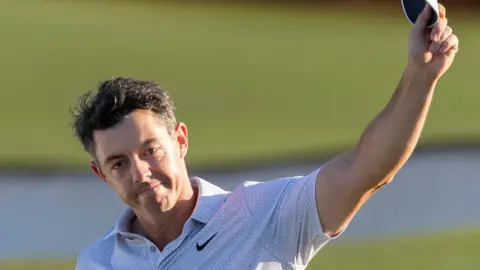 Rory McIlroy waves his cap to the Masters crowd
