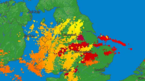 Lightning Maps A computer-generated image of a map of the UK with red, orange and yellow cross over it showing lightning strikes