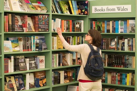 A woman browses a bookshop at Hay Festival