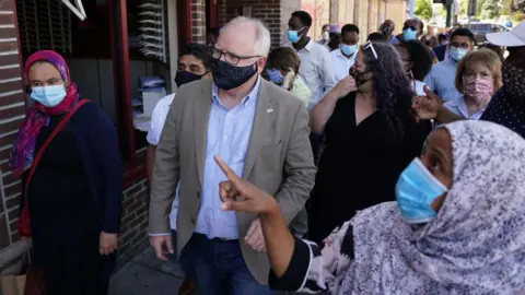 Getty Images Tim Walz touring impacted areas of Minneapolis in June 2020