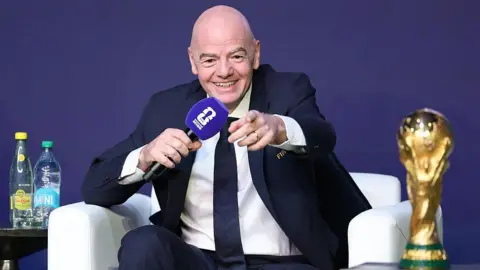Fifa president Gianni Infantino speaking into a microphone during the Fifa World Cup 2026 official match schedule announcement