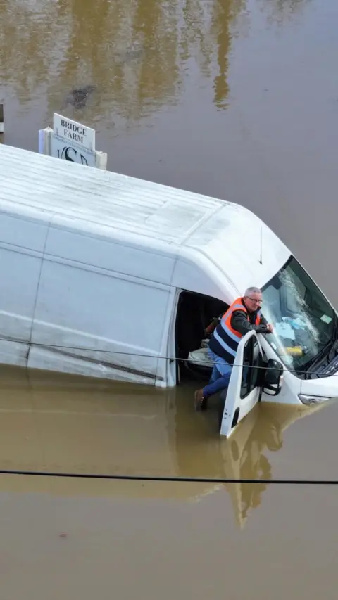 A van submerged in flooding.