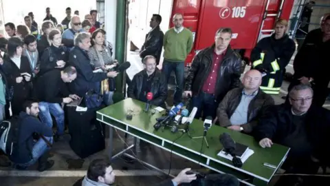 BALINT PORNECZI/AFP Hungarian Prime Minister Viktor Orban (standing 3R) listens to a journalist's question at the fire station headquarters in Ajka, 140kms west of Budapest on October 9, 2010