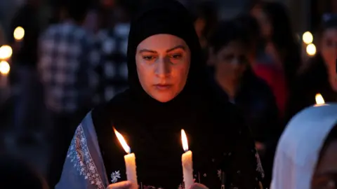 A demonstrator holds candles during a candle light vigil to condemn a suspected militant attack on tourists near south Kashmir’s scenic Pahalgam, in Srinagar April 23, 2025. REUTERS/Adnan Abidi
