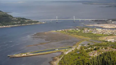 Nick Sidle An aerial view of the reserve on the Beauly Firth. Also visible are houses of Merkinch and South Kessock, the Kessock Bridge and the marina next to it. The long channel in the foreground is part of the Caledonian Canal.