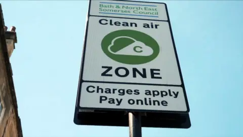 BBC Road sign that reads - 'Bath and North East Somerset Council. Clean Air Zone. Charges apply. Pay Online'.