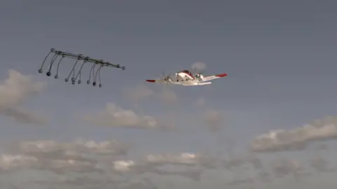 Ben Debuse/BBC A computer-generated image shows a red and white light aircraft approaching a black rack-like structure featuring black balls connected by thin rods. It resembles a toast rack. Behind the aircraft is a blue sky with white and grey clouds. 