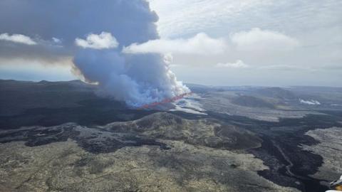 Smoke billows in the air after the eruption of a volcano in Iceland
