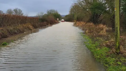 DWFRS A road completely submerged in water.