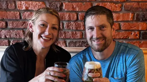 Christine Brant Christine Brant and Paul Warren smiling at the camera, each holding a pint of beer. Christine has shoulder length, blonde hair and is wearing a black zip-up. Paul Warren has short, brown hair and brown stubble. He is wearing a blue T-shirt.