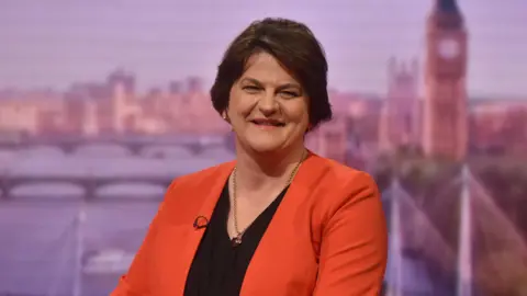 Baroness Arlene Foster sitting in TV studio smiling 