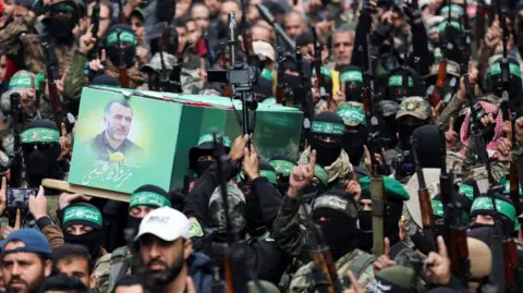 Reuters Armed Hamas militants carry the coffin of senior military commanded Marwan Issa in the central Gaza Strip