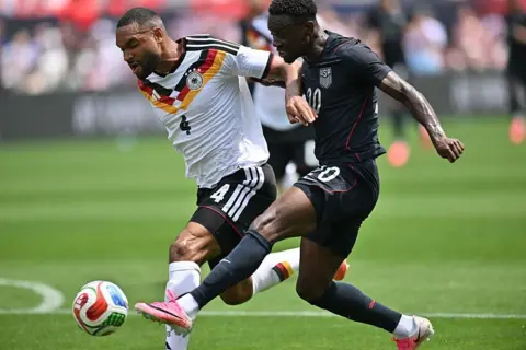 Getty Images United States striker Folarin Balogun (20) controls the ball against Germany center back Jonathan Tah (4) 