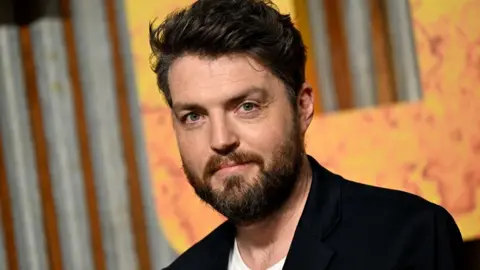 Getty Images Tom Burke attends the UK premiere of "Furiosa: A Mad Max Saga" at the BFI IMAX Waterloo on May 17, 2024 in London, England