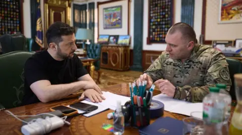 Ukrainian President Volodymyr Zelensky speaks with the Head of the Security Service (SSU) Vasyl Maliuk, who was reporting on the operation against Russian airbases