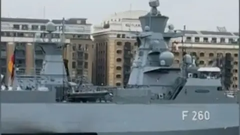 The German subject   ship, which is ample  and grey and has the fig   F260 connected  the broadside  successful  white