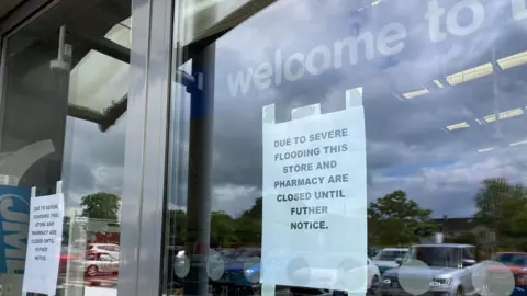 Sign in Boots store about flooding