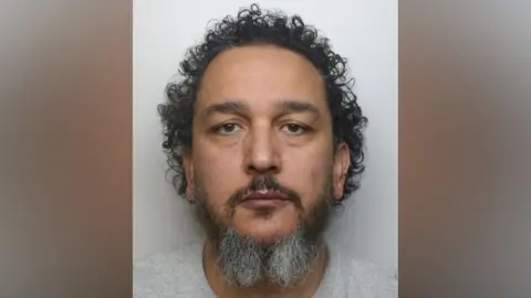 Northamptonshire Police A prison mug shot of a man in a grey t-shirt looking at the camera. 