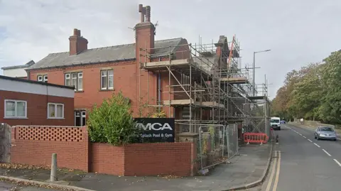 Google Exterior of the former YMCA Rural Splash Pool with scaffolding at the front of the building on Station Road, Kirkham 