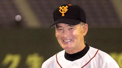 Shigeo Nagashima wearing a baseball cap and jersey
