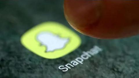 The Snapchat icon on a smartphone