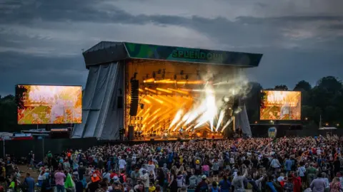 Stage with crowds watching and lights shining