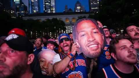 Getty Images Knicks fans gather in a park in NYC