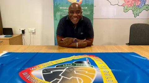 Charles Dacres with the 75th Anniversary Windrush flag 