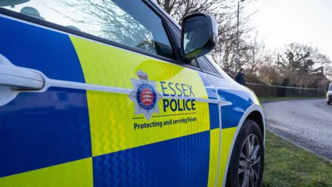 A Essex Police branded car parked on the side of the road