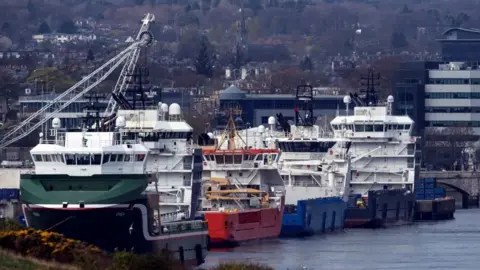 Getty Images A row of large ships harboured in Aberdeen