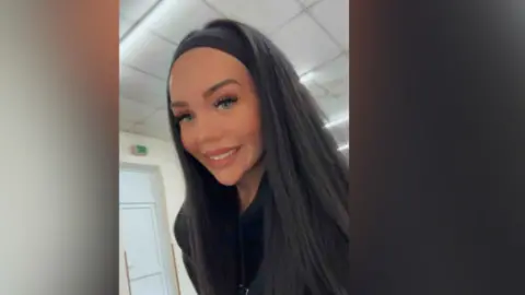 Liv Flanagan has dark hair and wears a black hoodie and headband