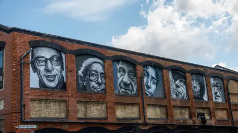 A general view of Abraham O's seven spray-painted black and white up-close murals on Hare Marsh in Shoreditch.