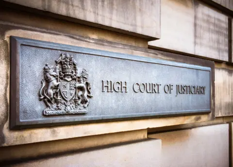 Metal sign saying High Court of Justiciary