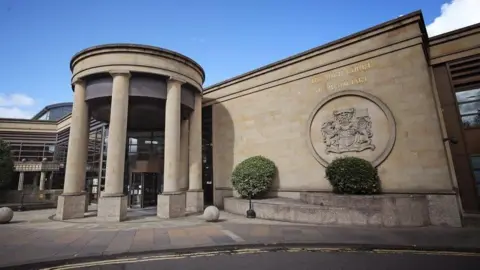 Exterior image of the beige sandstone High Court of Glasgow building
