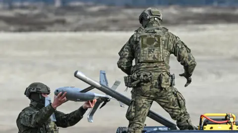 Getty Images Polish Army soldiers prepare an interceptor drone during a live-fire demonstration in Poland in November 2025