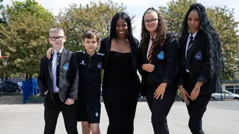 Pupils pictured with a behaviour coach in a playground