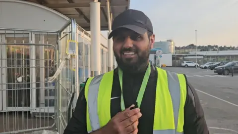 aisha iqbal/bbc Supermarket worker Hassan Farooq
