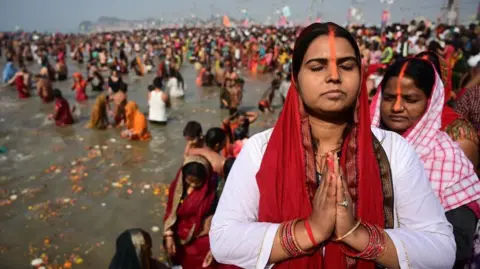 REX/Shutterstock Image shows Hindu devotees taking a dip and pray ahead of the second sacred bathing ritual during the Kumbh Mela festival in Prayagraj, northern state of Uttar Pradesh, India, 28 January 2025