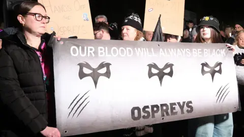 Ospreys fans have protested against the proposed bid by their owners to buy Cardiff from the Welsh Rugby Union (WRU)