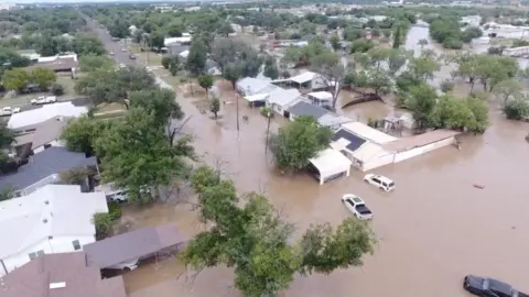 A drone view shows flooded houses, following torrential rains that unleashed flash floods