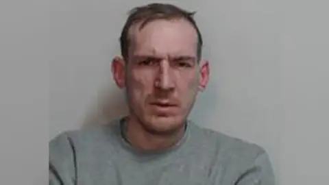 Police scotland a Pulphot Policeman man with short brown hair and wearing gray tights.