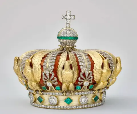 Louvre Museum A gold crown adorned with diamonds, green emeralds and eagles moulded from gold which was taken from the Louvre Museum