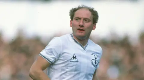 Getty Images Alan Brazil in action for Tottenham Hotspur in March 1983. He is wearing a white Spurs top.