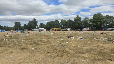 The Community Food Project A large field strewn with litter and rubbish as well as abandoned tents