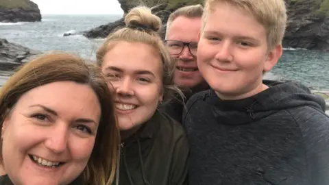 Priestley family Family picture of the Priestley family with sea and cliffs behind them.
