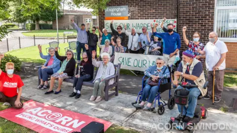Local Democracy Reporting Service/Acorn A group of older people stood with signs and banners outside Espringham House in Swindon.