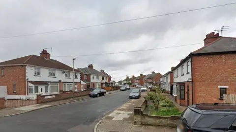 Google A street level view of a suburban residential road with two-storey semi detached houses.