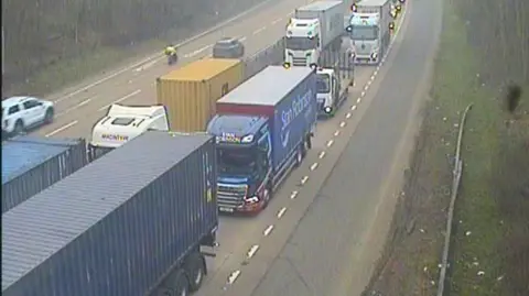 Traffic backed up on part of the A14. Vehicles can be seen nearly bumper to bumper on one of the carriageways.